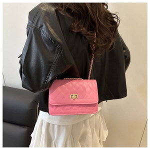 Detailed close-up of pink quilted PU leather crossbody bag with golden chain strap