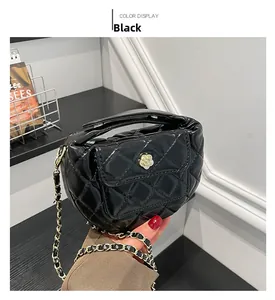Detail of black quilted moon bag with white camellia buckle and golden chain strap