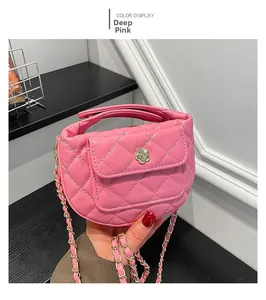 Close-up of deep pink quilted bag with golden camellia clasp and chain strap