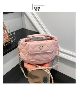 Close-up of light pink quilted mini handbag featuring gold flower lock and chain strap