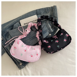 Detail of floral hobo bags with scrunchie handles in pink and black floral pattern
