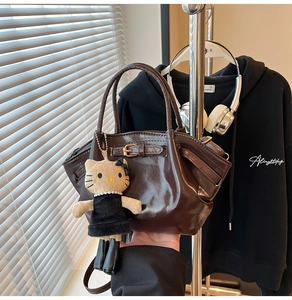 Retro brown patent leather handbag with buckle and cute knit kitten doll charm