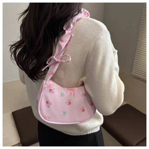 Detailed back view of a pink floral underarm bag with ribbon bow and ruched strap