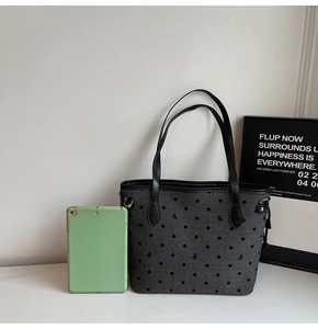 Détail du sac cabas gris à pois noirs avec une tablette pour illustrer la capacité