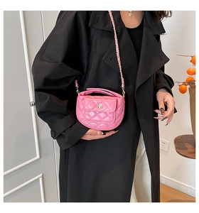 Pink quilted PU leather mini bag with gold flower buckle shown on a model
