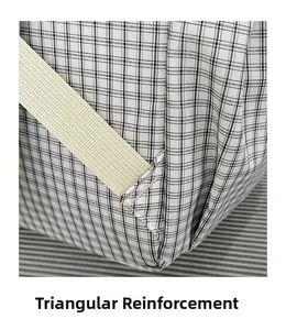 Detail showing triangle-reinforced stitching on the black and white checkered backpack strap