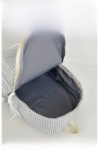 Internal display of the large capacity black and white plaid backpack showing gray lining