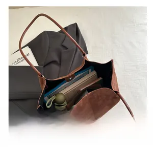 Brown faux suede tote bag interior showing large capacity for books and tablet
