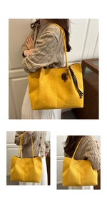 Detail of yellow suede tote bag with decorative scarf and wooden ring charm