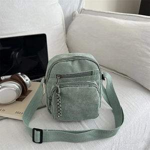 Sac bandoulière minimaliste en velours côtelé vert clair avec design multi-poches