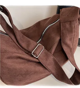 Detail of coffee corduroy crossbody bag with adjustable strap and silver metal buckle