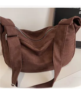 Close-up of wide strap and silver buckle on corduroy tote bag with vertical texture