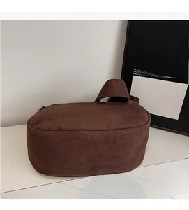 Detail view of large dark brown suede tote bag featuring soft fabric and wide handle