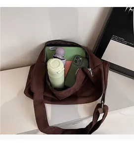 Interior view of spacious dark brown suede crossbody bag with tablet and daily essentials
