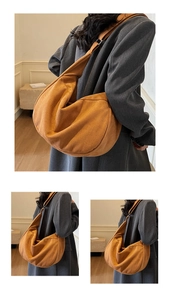 Detailed close-up of a large ginger yellow suede hobo bag with high-quality matte finish