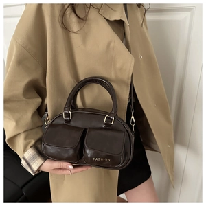 Detail of dark brown vintage bowling bag with front pockets and fashion text