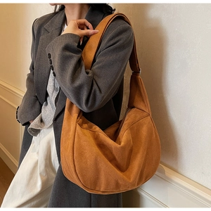 Detailed view of ginger hobo bag with soft velvet texture on a model's shoulder