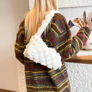 Minimalist white fuzzy plush shoulder bag with woven texture for women in cozy interior