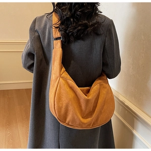 Detail of caramel suede crescent tote bag showing large capacity and soft draping
