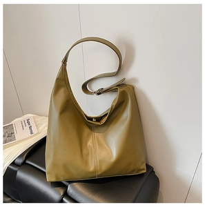 Close-up of olive green Hobo bag showing vertical stitching and magnetic buckle closure