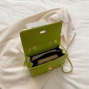 Grass green quilted shoulder bag with gold chain and interior showing phone and wallet