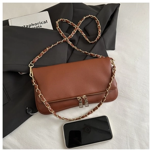 Litchi pattern shoulder bag shown with phone and book to display storage capacity