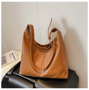 Close-up of brown PU leather tote bag with matte finish and reinforced stitching
