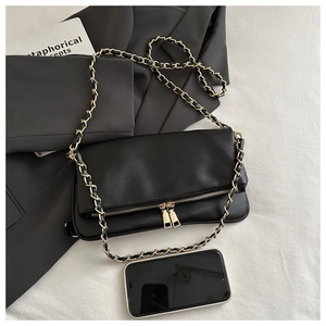 Detailed view of black lychee grain leather bag with gold chain and size reference