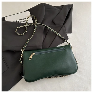 Detail of dark green lychee texture shoulder bag with gold zipper pocket and chain strap