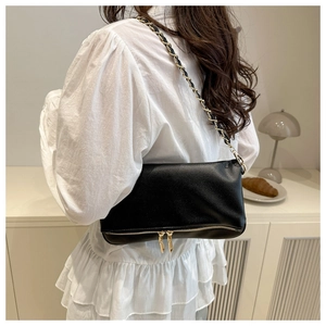 Chic black litchi pattern leather shoulder bag with golden chain and zipper details