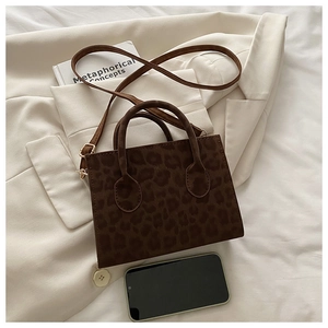Detail of leopard print mini tote with gold hardware and stylish suede texture