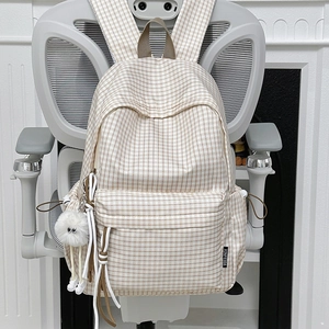 Vintage plaid backpack with large capacity and plush pendant on ergonomic chair