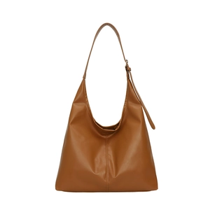 Detail view of brown PU leather shoulder bag with metallic buckle and glossy finish
