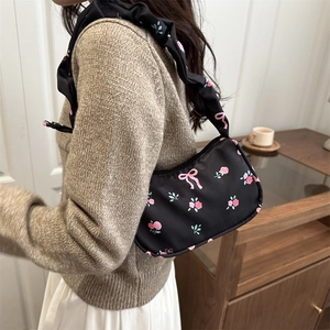 Floral black shoulder bag with pink roses, bow patterns and ruffled cloud strap