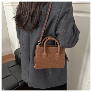 Brown leopard print crossbody bag styled on a grey wool blazer for winter fashion outfit