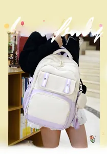 Detail of multi-pocket student backpack in cream and lavender with small round coin pouch