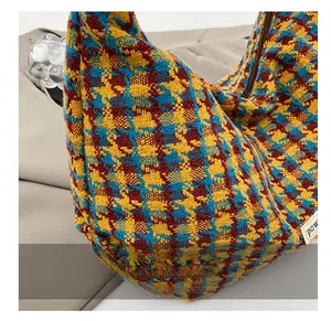Detailed macro of vintage houndstooth fabric texture and zipper on large tote bag