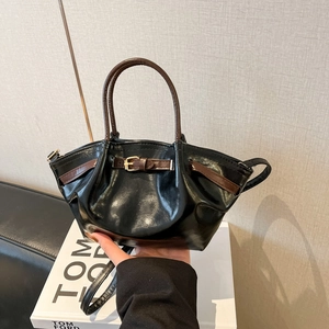 Chic black matte leather tote bag with dark brown handles and adjustable shoulder strap