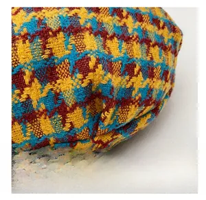 Detail of colorful houndstooth fabric texture and reinforced bottom stitching of the bag