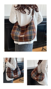 Detail of vintage brown plaid wool shoulder bag with power off label and woven texture