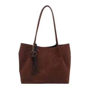 Minimalist large brown suede tote bag with slim shoulder straps and pretzel charm