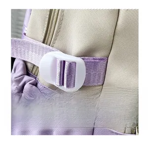 Detail of durable beige canvas backpack showing purple webbing and fixed white buckle strap