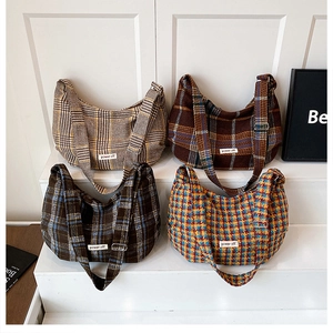 Detail view of four colorful checkered crossbody hobo bags with Power Off woven labels