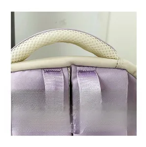 Detail of lavender backpack top handle featuring breathable beige mesh padding and fine stitching