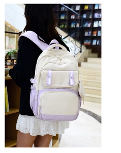 Side view of cream and lavender student backpack featuring a multi-pocket nylon design