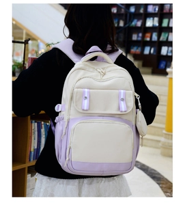 Detail of Korean style campus backpack in cream and lavender with small coin purse pendant