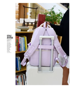 Detail of light purple backpack with travel luggage strap for suitcase attachment