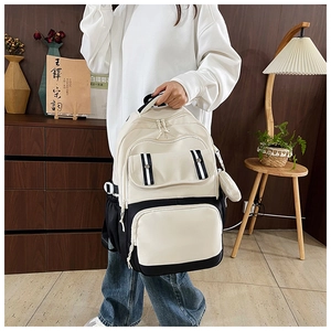 Detail of a large capacity canvas backpack featuring black and white contrast design