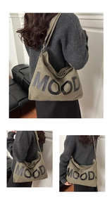 Three-way split view of a dark green canvas tote bag with MOOD lettering detail