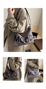 Detailed macro view of the large grey suede tote bag with solid black MOOD lettering print